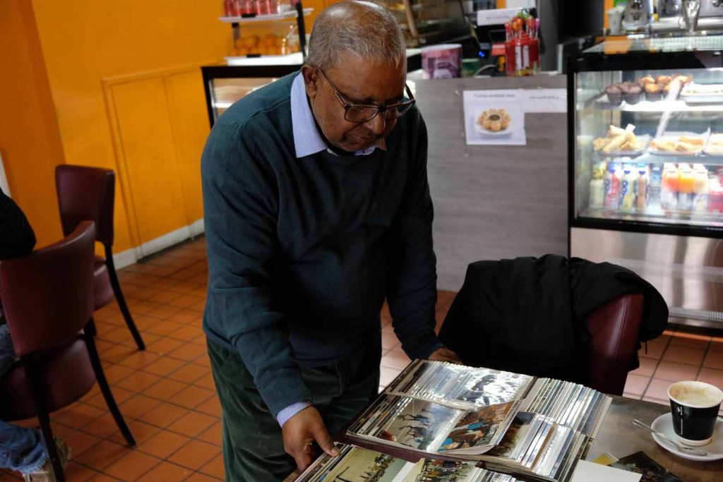 Salim Ullah looking through family albums of photographs.