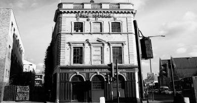 A black and white photo of the entrance of The George Tavern, Whitechapel.