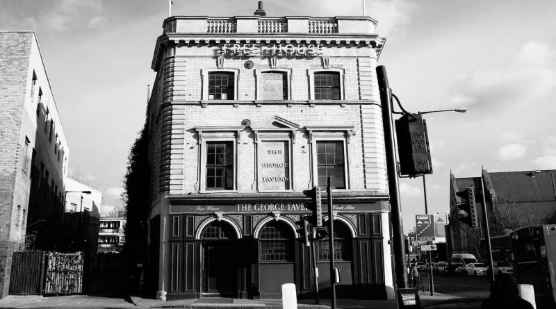 A black and white photo of the entrance of The George Tavern, Whitechapel.