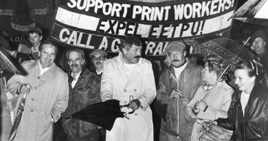 Strikers in Wapping holding up a Workers Revolutionary Party banner during the Print Union Workers Strike in the 1980s.