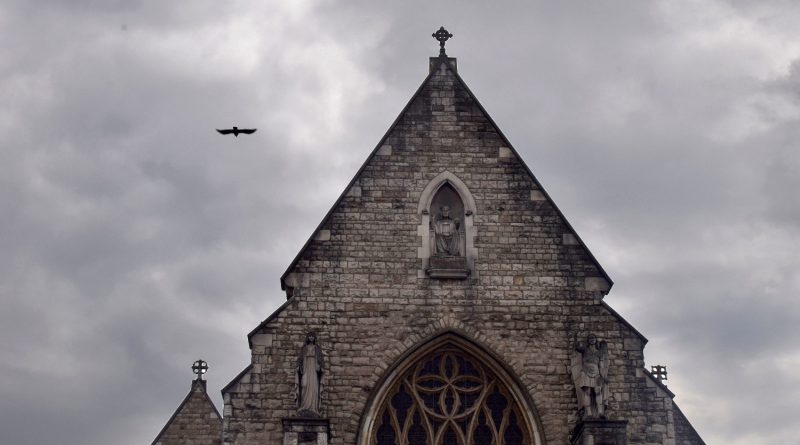 A bird flying past the steeple of The Church of St Mary & St Michael on Commercial Road, East London.