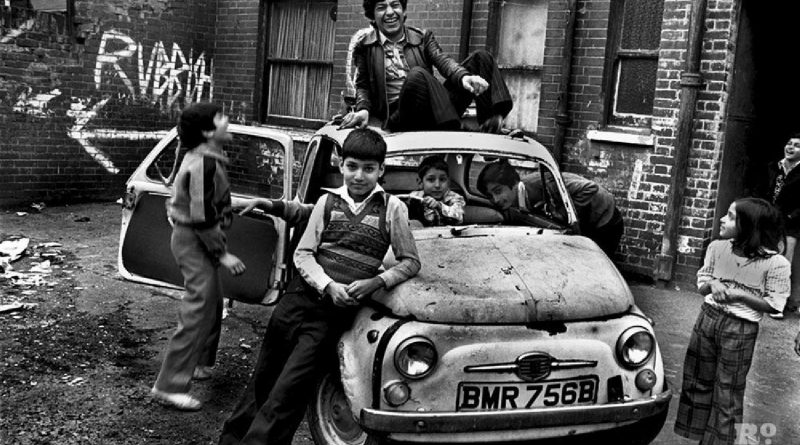 British Bengali children sitting on a car outside of a squat near Brick Lane.