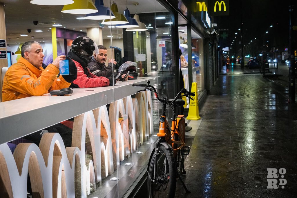 Cycle couriers taking a break at MacDonals in Whitechapel, East London, from a photo essay shot by photographer Matt Payne.