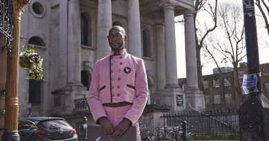 Ricardo, the cake concierge, stands in front of Christ Church, Spitalfields East London with a Hummingbird Bakery delivery before it reopens