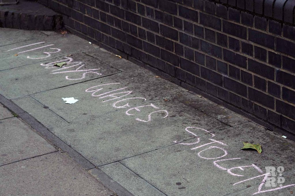 '113 days of wages stolen' written in chalk on the pavement as part of Queen Mary University staff strikes.