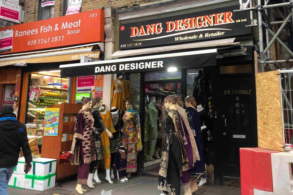 The street view of Dang Designer saree shop on Whitechapel Highstreet, displaying sarees for sale.