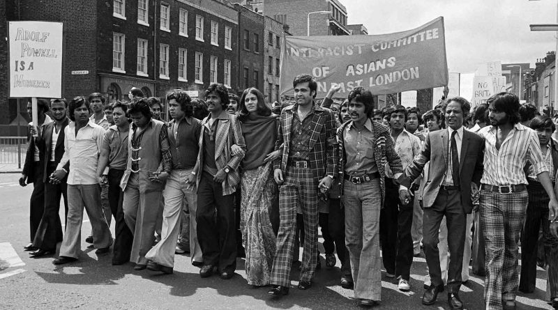 The Anti-Racist Committtee of Asians in East London marching down Whitechapel Road in 1976, bearing the banner 'Adolf Powell is a Murderer.