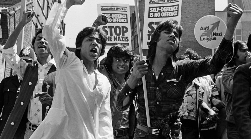 Passionate Bengali protestors waving their fists in the air and holding Anti-Nazi League banners at a Brick Lane demonstration in 1978, Whitechapel.