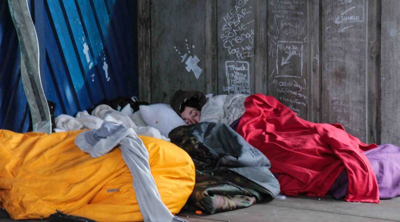 Homeless person sleeping in a sleeping bag in Shoreditch, East London.