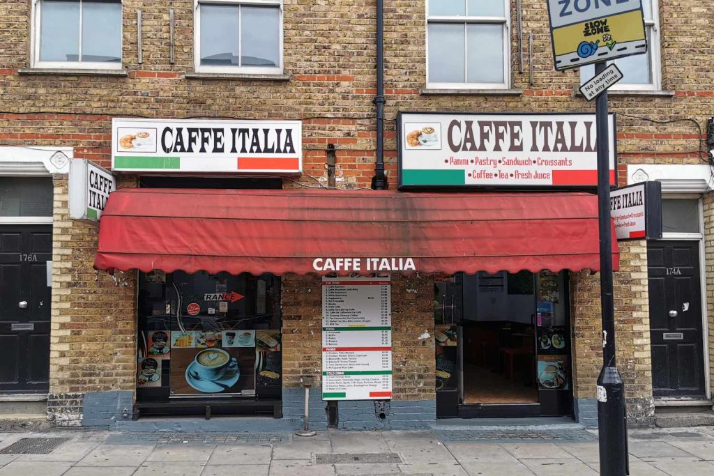 Outside Caffe Italia, a small cafe with an awning and decorated with the colours of the Italian flag 